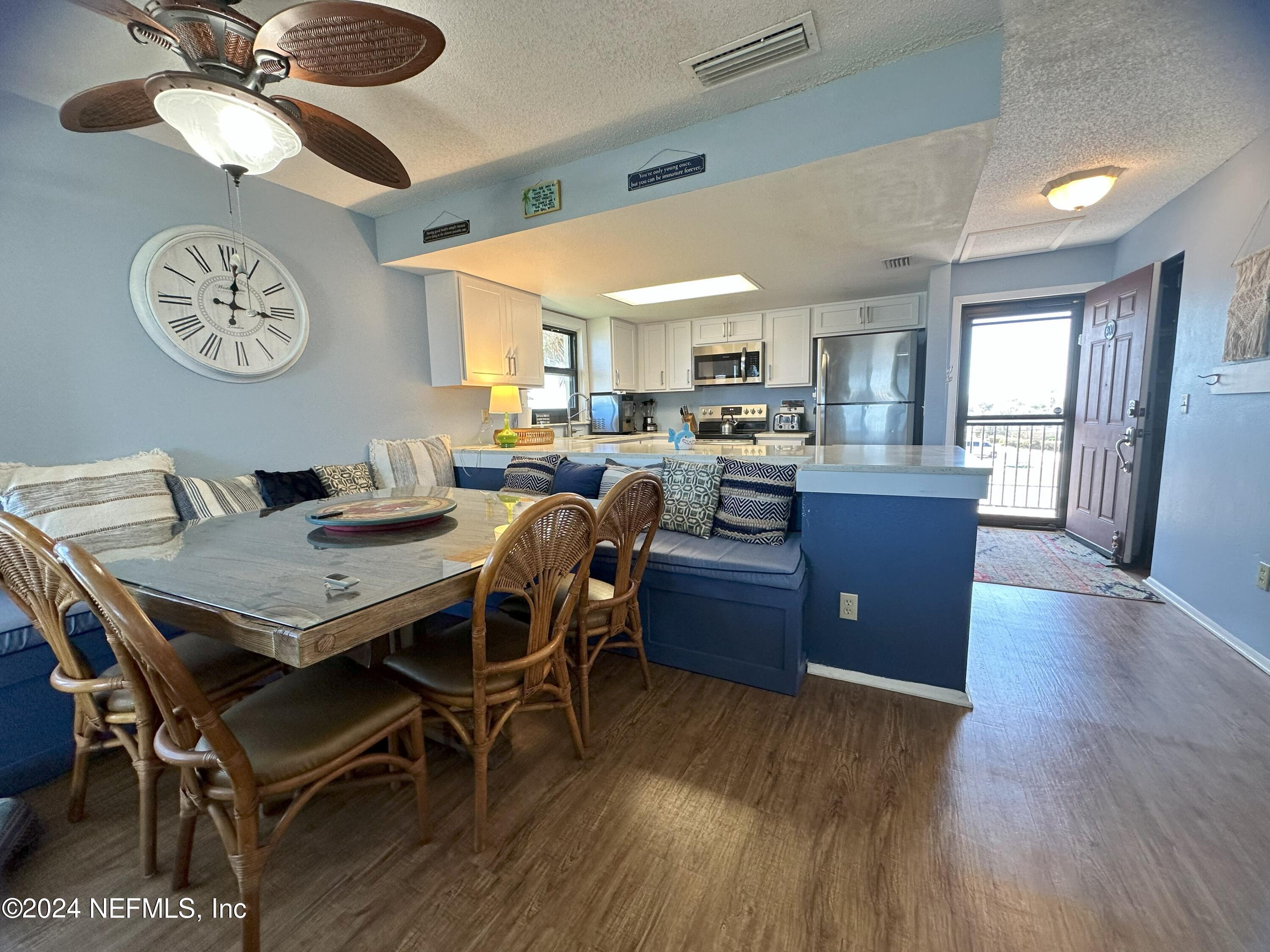 2100 Ocean Shore Boulevard, Unit 3010 Ormond Beach, FL 32176 - Photo 10 of 32 a view of a dining room with furniture window and wooden floor