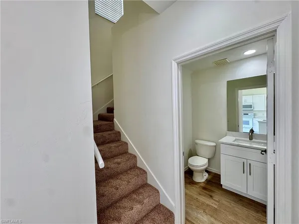 an empty room with a ceiling fan and window