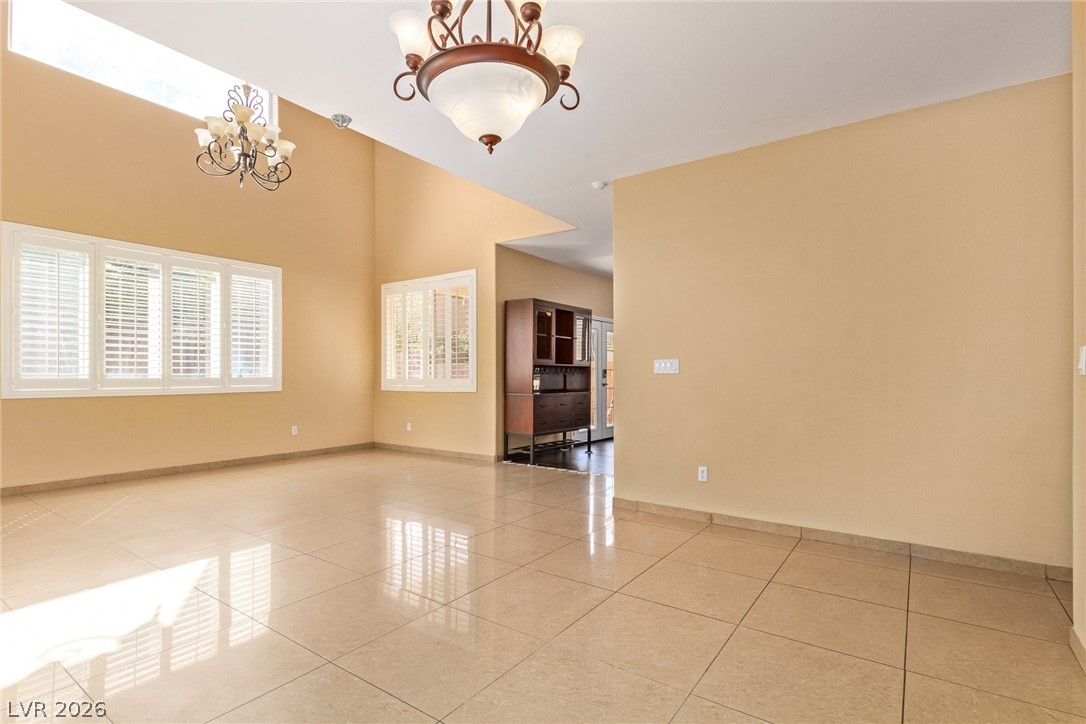 1477 Rancho Ridge Drive Henderson, NV 89012 - Photo 8 of 46 High vaulted ceilings complement the polished tile floors, creating an airy and open atmosphere.
