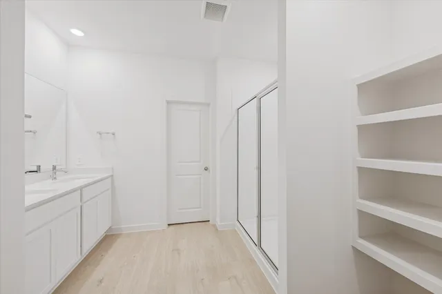 a bathroom with a double vanity sink and mirror