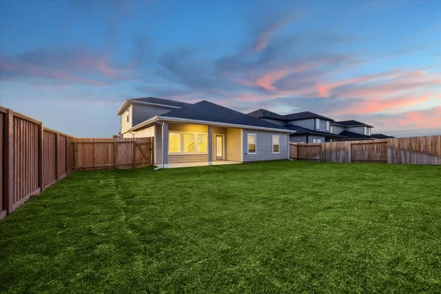 a view of a house with a back yard