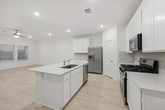 a kitchen with a sink stove and refrigerator