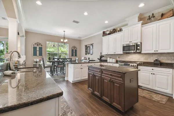 a kitchen with sink stove and cabinets