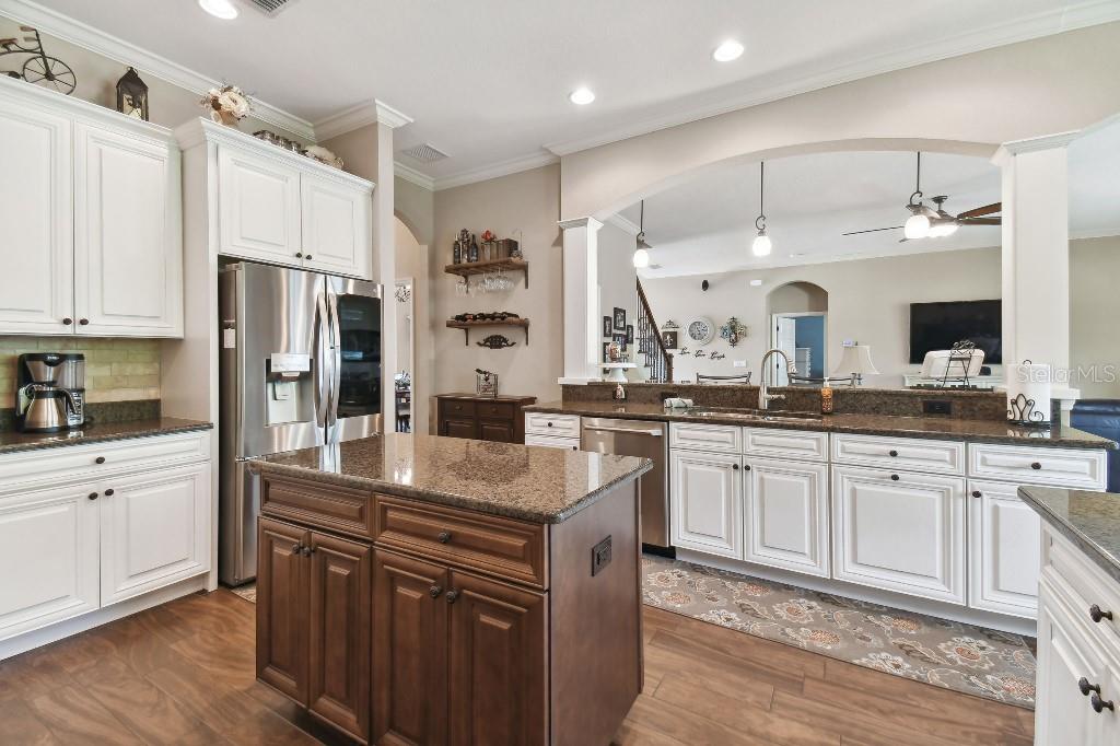 849 John Cressler Drive Seffner, FL 33584 - Photo 13 of 45 a kitchen with stainless steel appliances granite countertop a sink stove and refrigerator