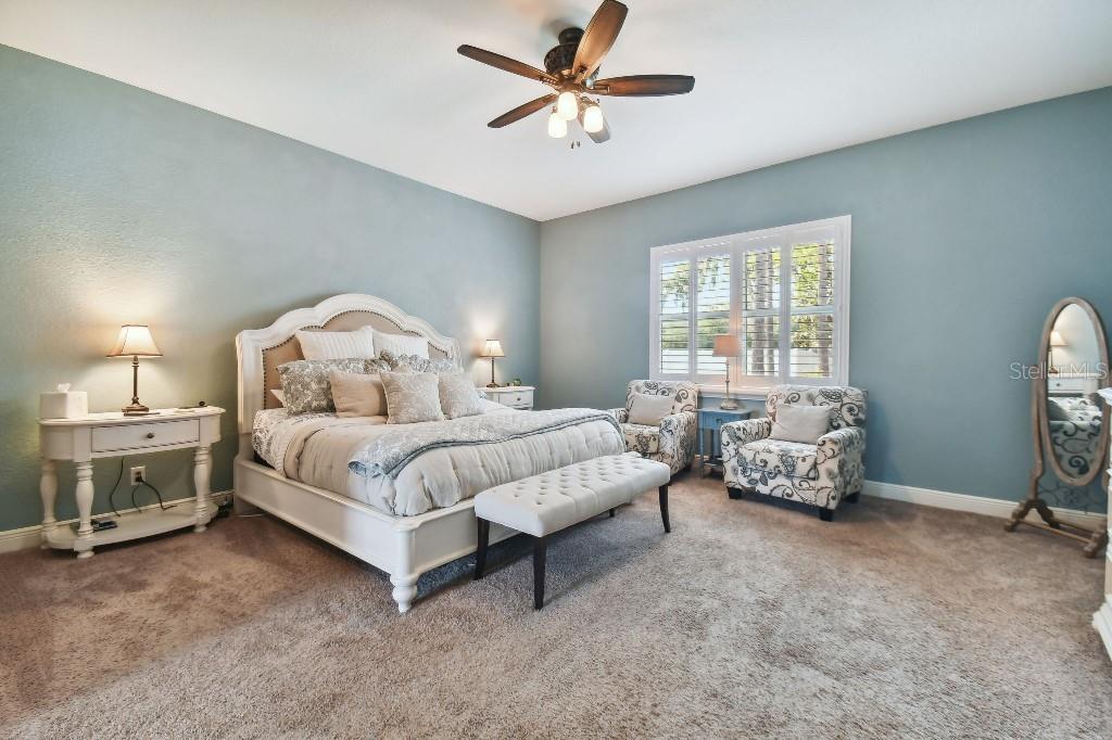 849 John Cressler Drive Seffner, FL 33584 - Photo 20 of 45 a bedroom with bed and a chandelier