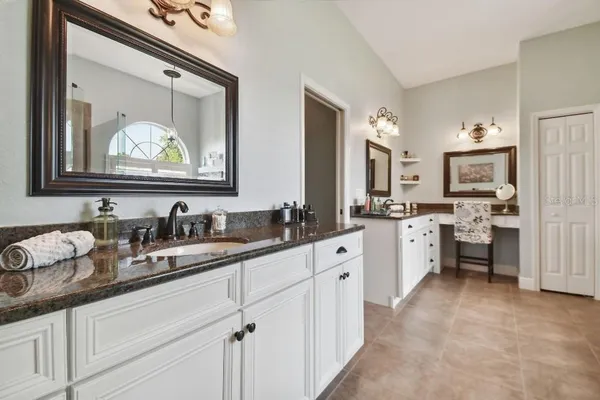 a kitchen with sink stove and cabinets
