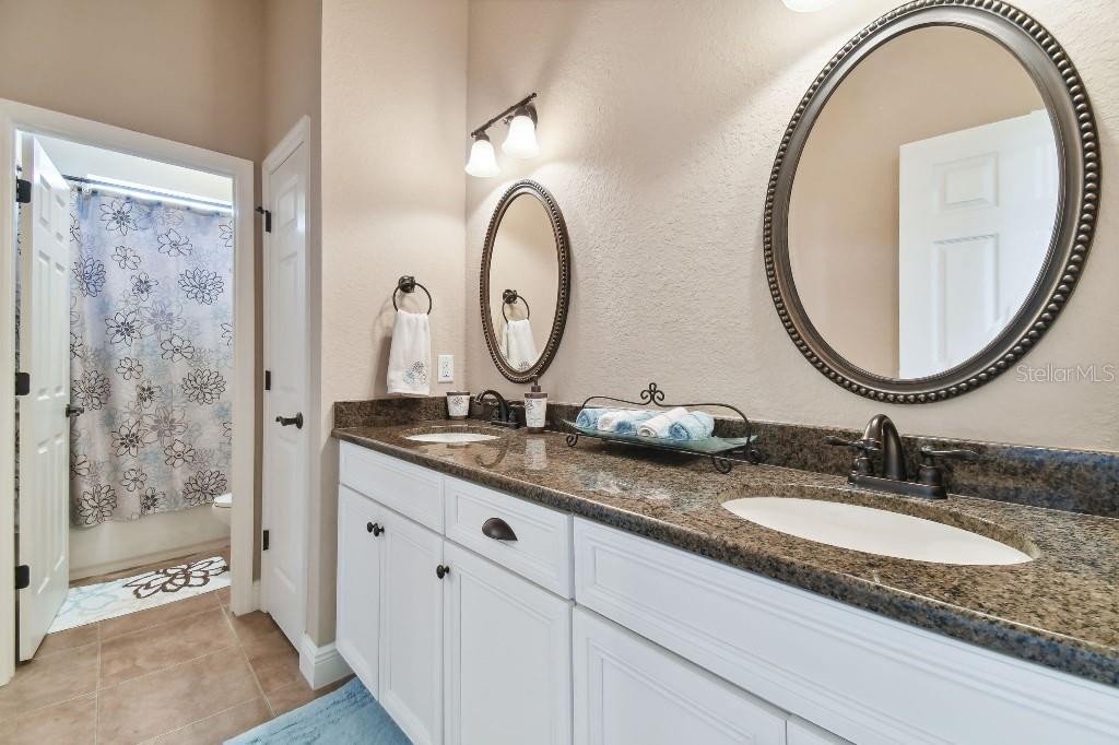 849 John Cressler Drive Seffner, FL 33584 - Photo 26 of 45 a bathroom with a granite countertop double vanity sinks and a mirror