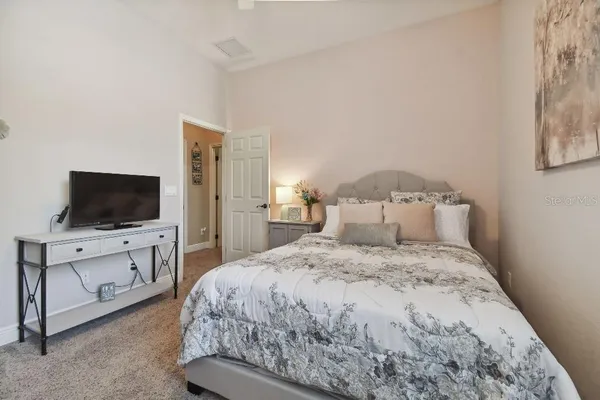 a bedroom with a bed and a flat screen tv