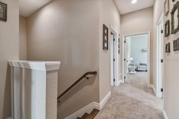 a view of a hallway with closet and a livingroom view