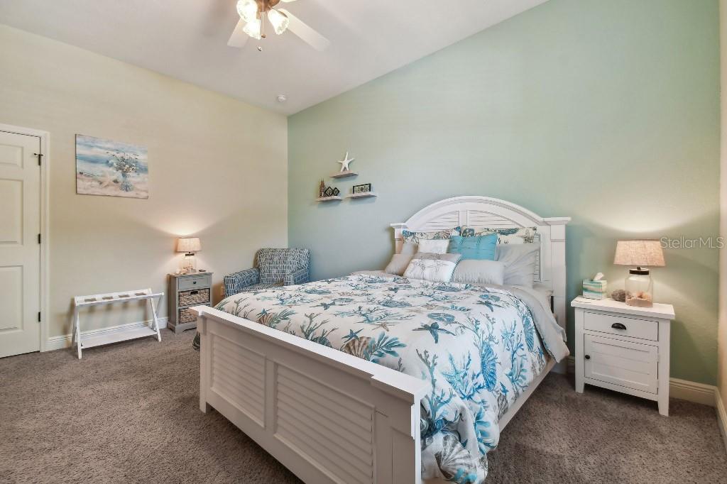 849 John Cressler Drive Seffner, FL 33584 - Photo 32 of 45 a bedroom with a bed and a chandelier