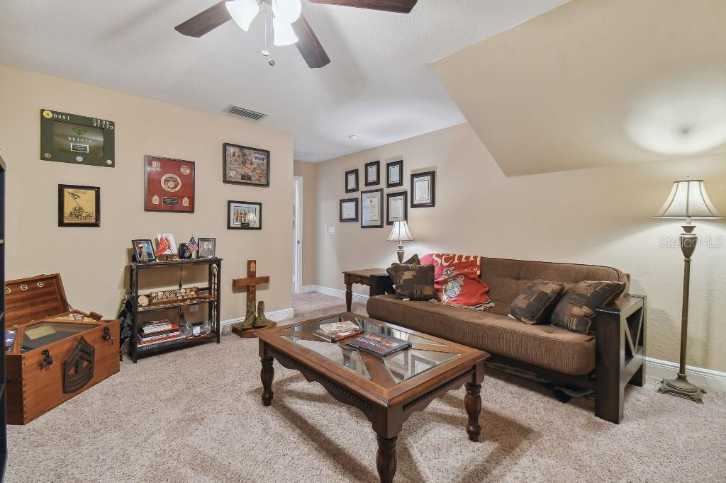 849 John Cressler Drive Seffner, FL 33584 - Photo 36 of 45 a living room with furniture a couch and a bookshelf