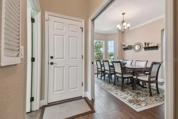 a view of a dining room with furniture and chandelier