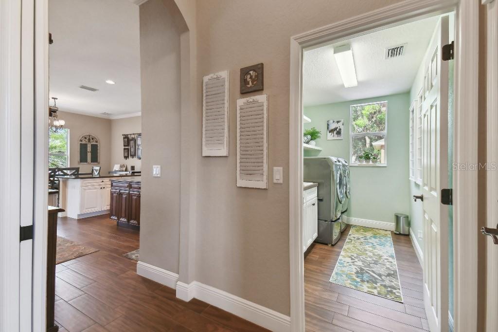 849 John Cressler Drive Seffner, FL 33584 - Photo 9 of 45 a view of a hallway with wooden floor and a living room