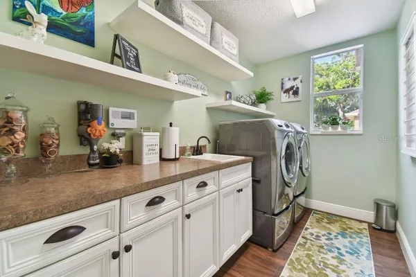 a view of a kitchen with fridge and window