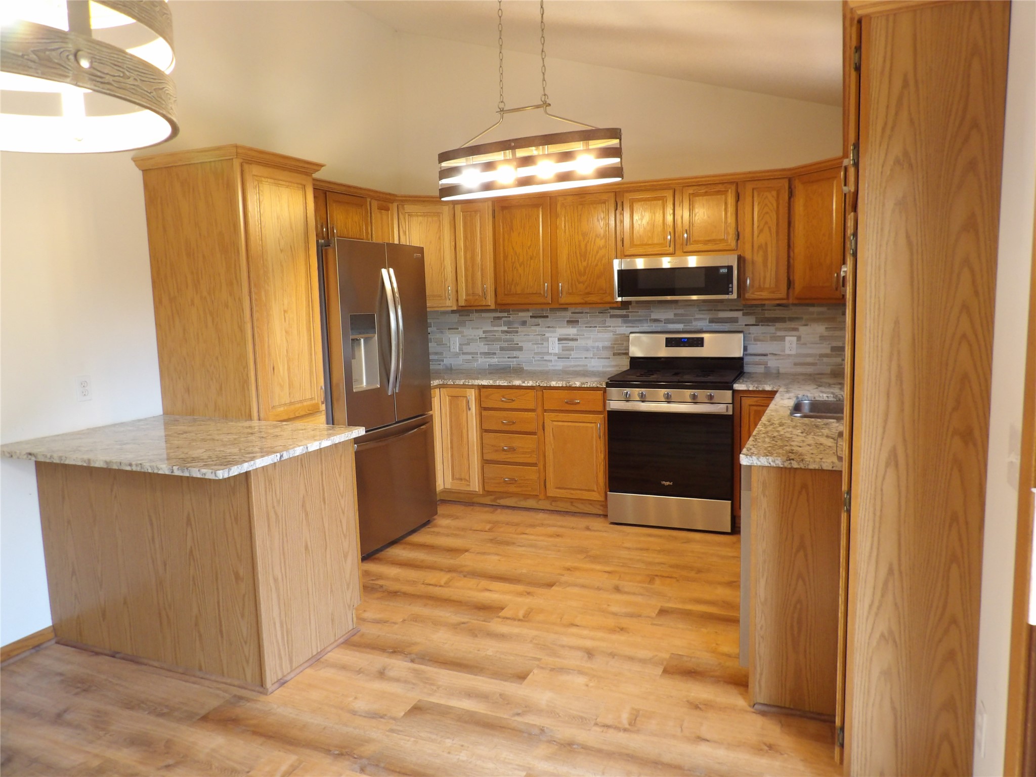 5213 La Rae Drive Erie, PA 16506 - Photo 8 of 46 The updated kitchen includes newer granite countertops, backsplash, and additional pantry cabinet and peninsula.