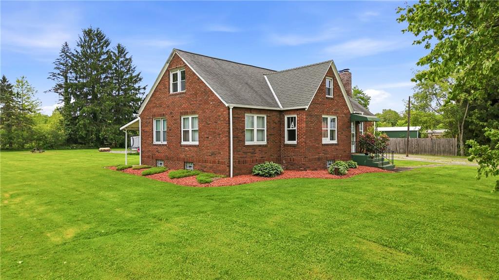 7376 Sharon-Mercer Road Mercer, PA 16137 - Photo 5 of 49 a front view of a house with a yard and trees
