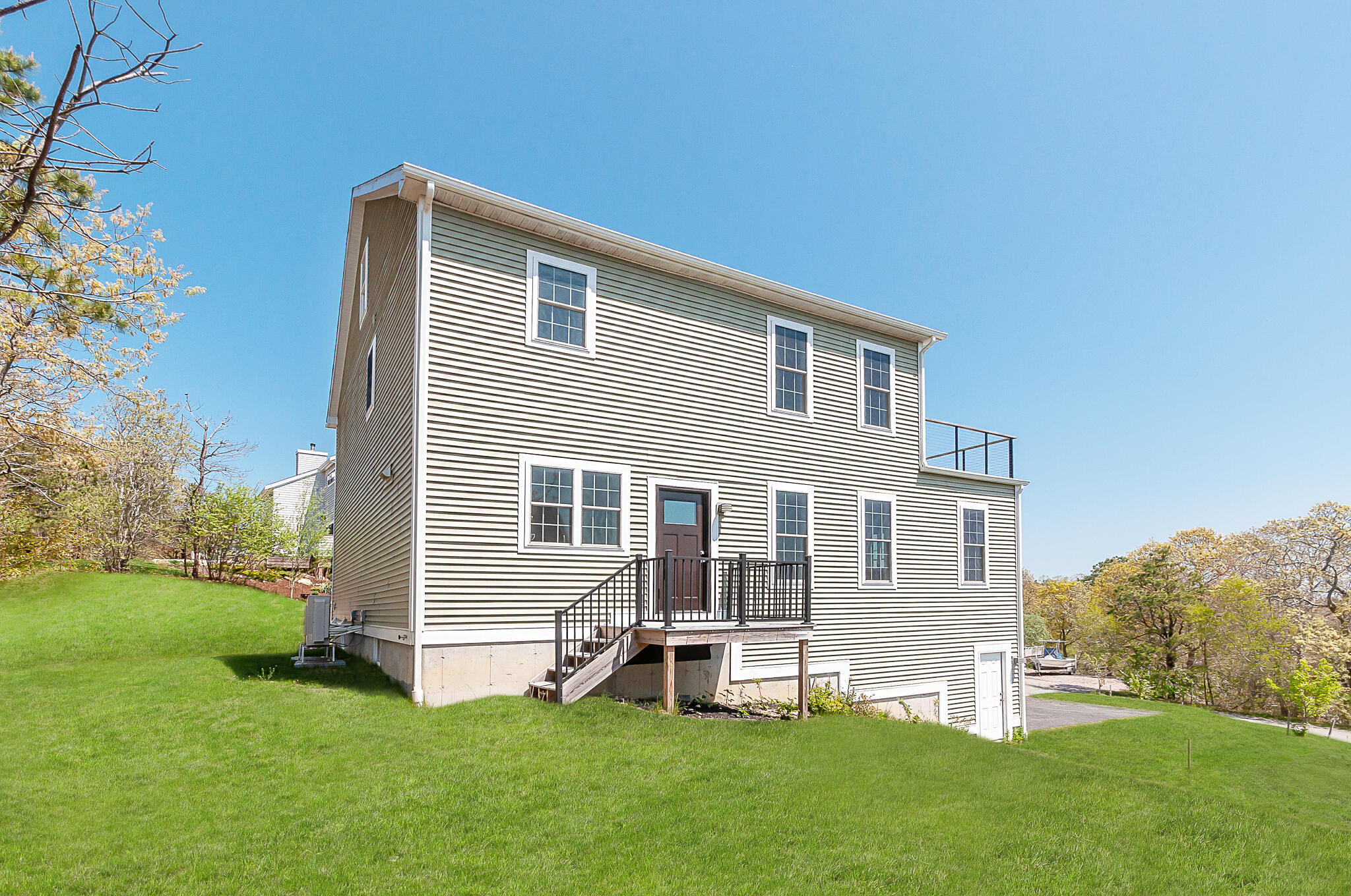 21 Sheppard Road Sagamore Beach, MA 02562 - Photo 4 of 33 a front view of a house with a yard and green space