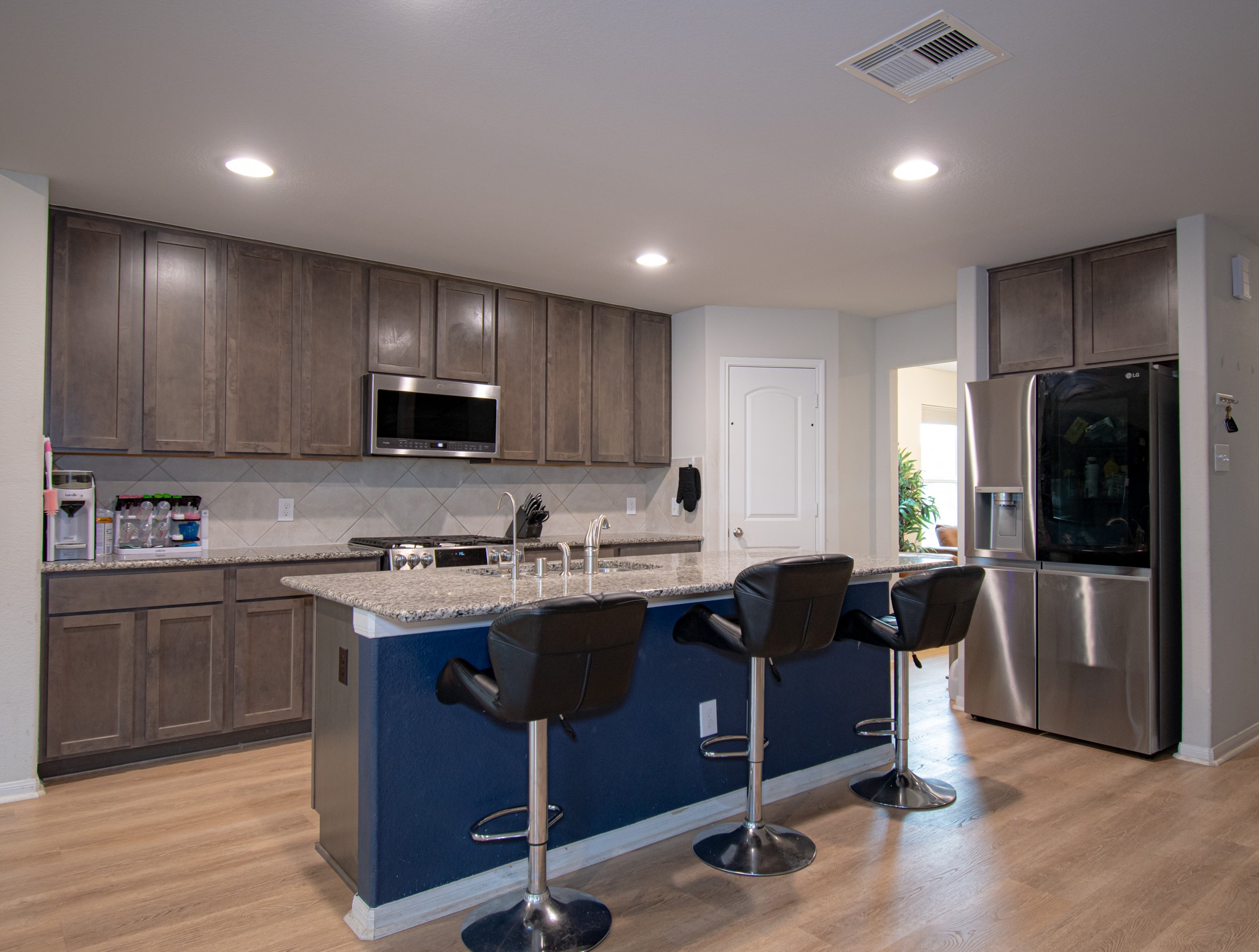 2642 Ridgeback Drive Rosenberg, TX 77471 - Photo 6 of 13 a kitchen with stainless steel appliances granite countertop a refrigerator a sink a stove a microwave and wooden cabinets