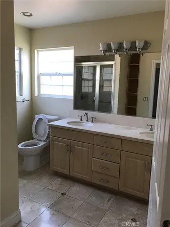 a bathroom with a sink double vanity and a mirror