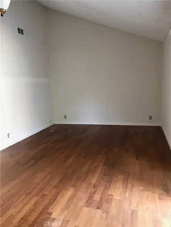 a view of room with wooden floor and fan