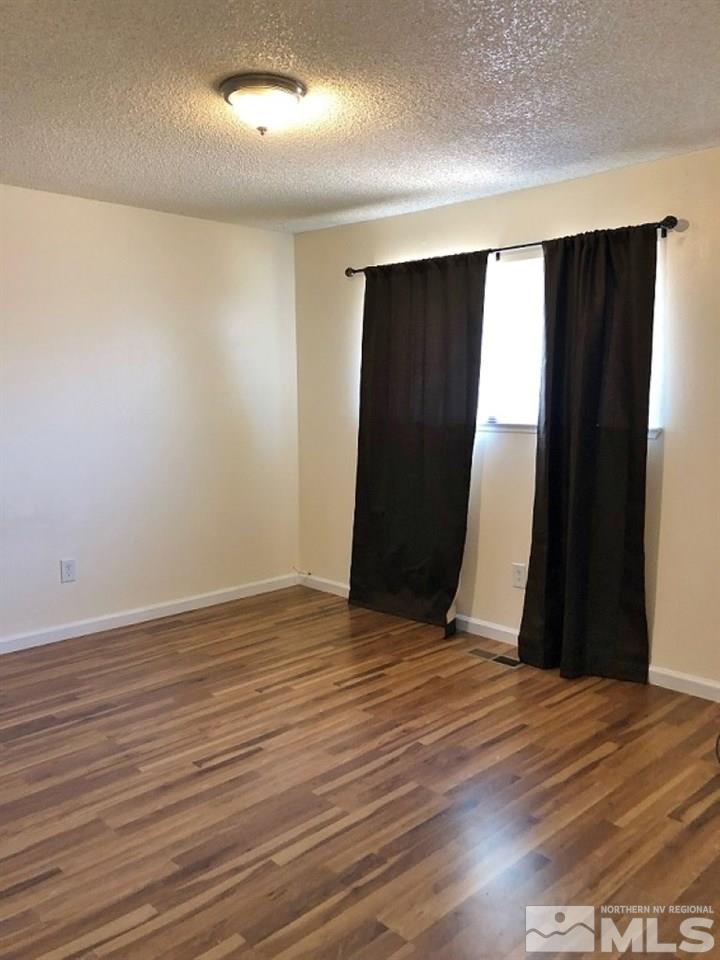 6541 Flower Street Reno, NV 89506 - Photo 11 of 14 an empty room with wooden floor and closet