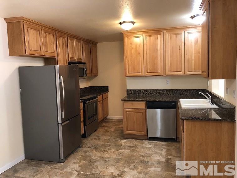 6541 Flower Street Reno, NV 89506 - Photo 3 of 14 a kitchen with a stove sink and refrigerator