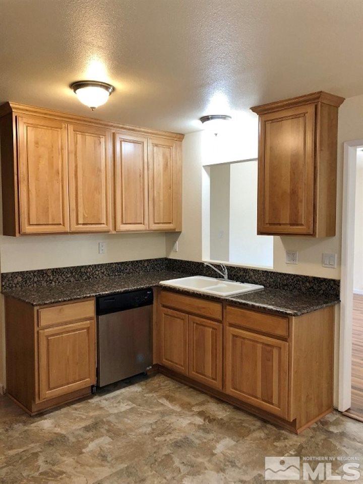 6541 Flower Street Reno, NV 89506 - Photo 4 of 14 a kitchen with granite countertop sink and cabinets