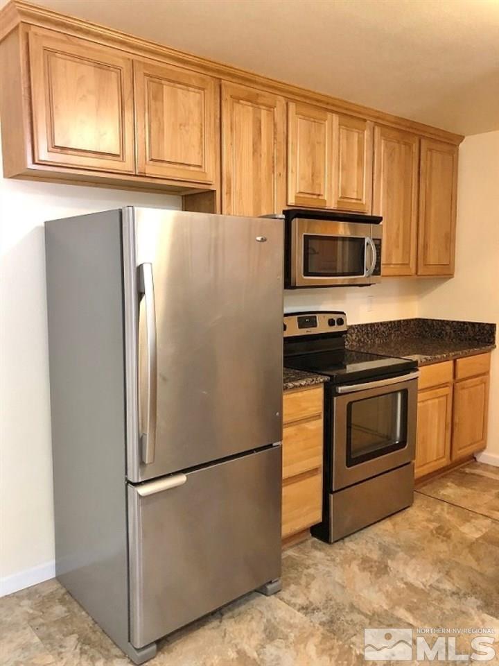 6541 Flower Street Reno, NV 89506 - Photo 5 of 14 a metallic refrigerator freezer sitting in a kitchen