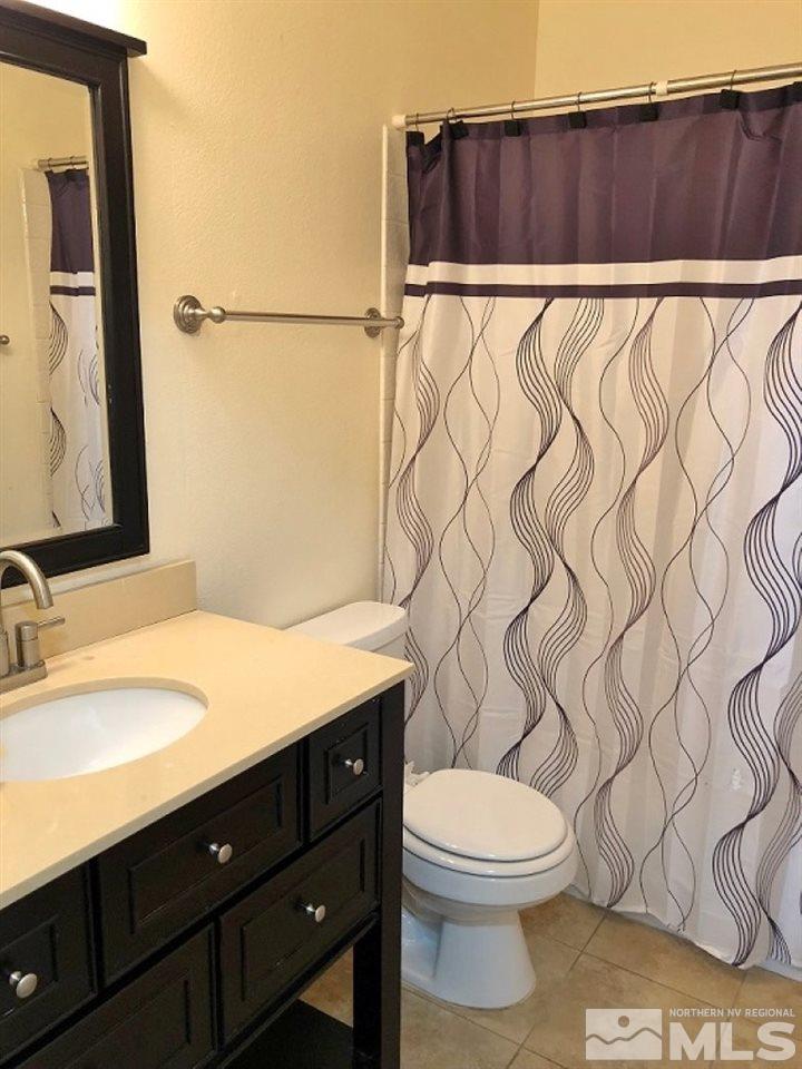 6541 Flower Street Reno, NV 89506 - Photo 8 of 14 a bathroom with a sink and a mirror