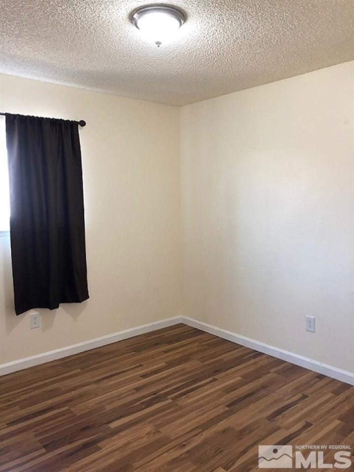 6541 Flower Street Reno, NV 89506 - Photo 9 of 14 a view of an empty room with wooden floor