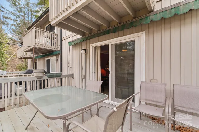 a roof deck with table and chairs
