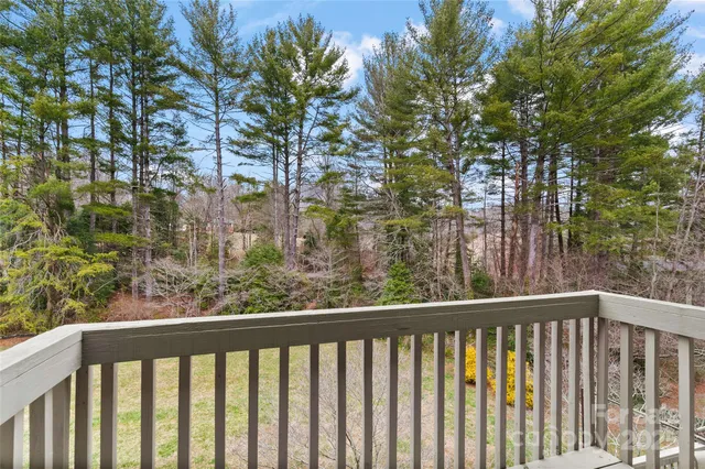 a view of a balcony with wooden fence and floor