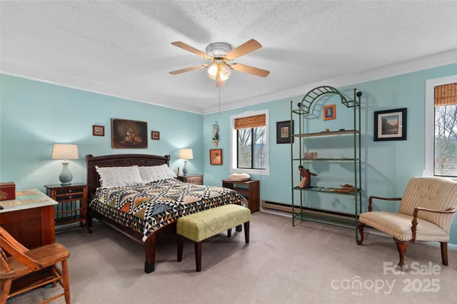 a bedroom with a bed a couch and a chandelier