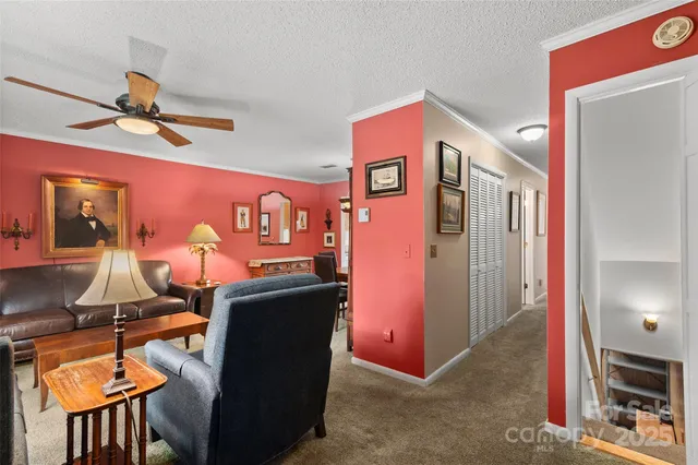 a hallway with furniture and a large window