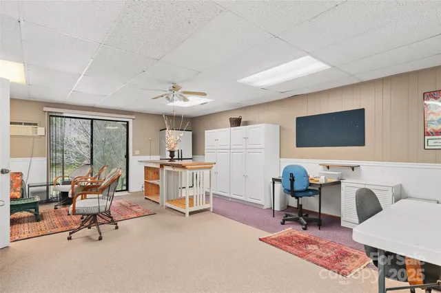 a living room with furniture a rug and a painting on the wall