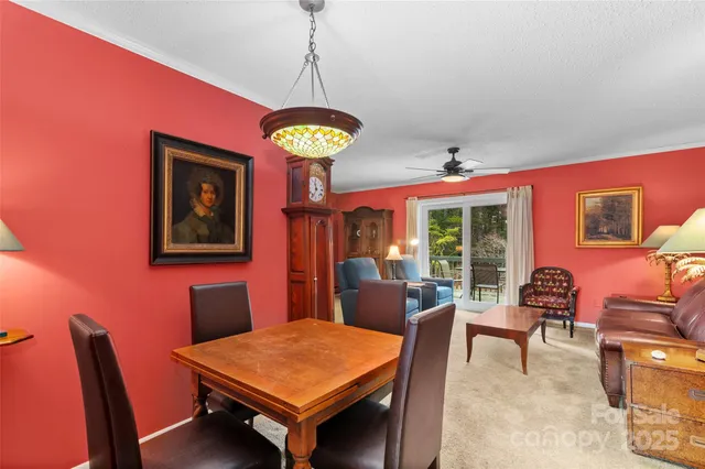a dining room with wooden floor a chandelier a wooden table and chairs