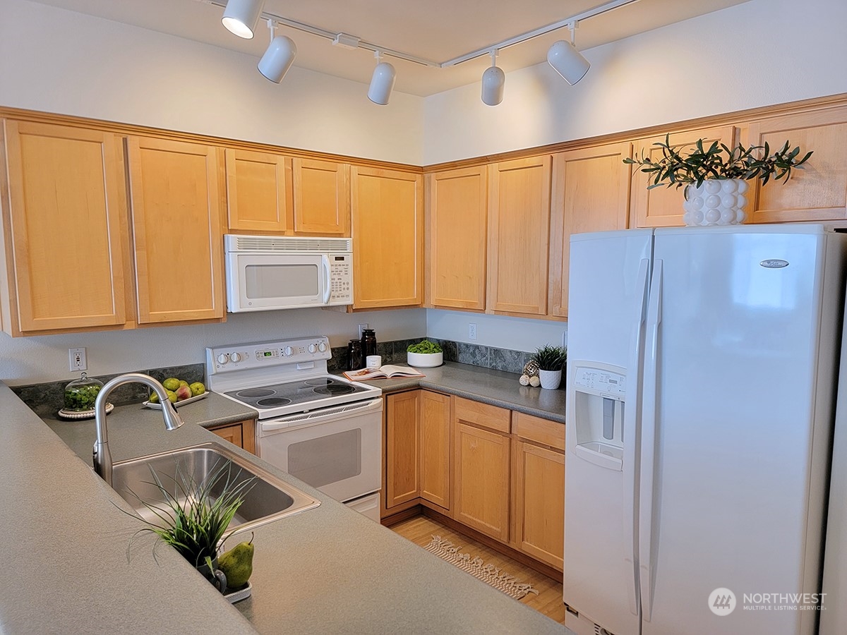 440 Maple Avenue Southwest, Unit A203 Renton, WA 98057 - Photo 12 of 33 a kitchen with a sink appliances cabinets and a window