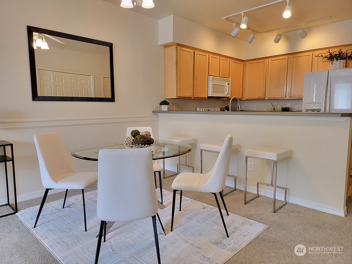 440 Maple Avenue Southwest, Unit A203 Renton, WA 98057 - Photo 14 of 33 a view of a dining room with furniture and wooden floor