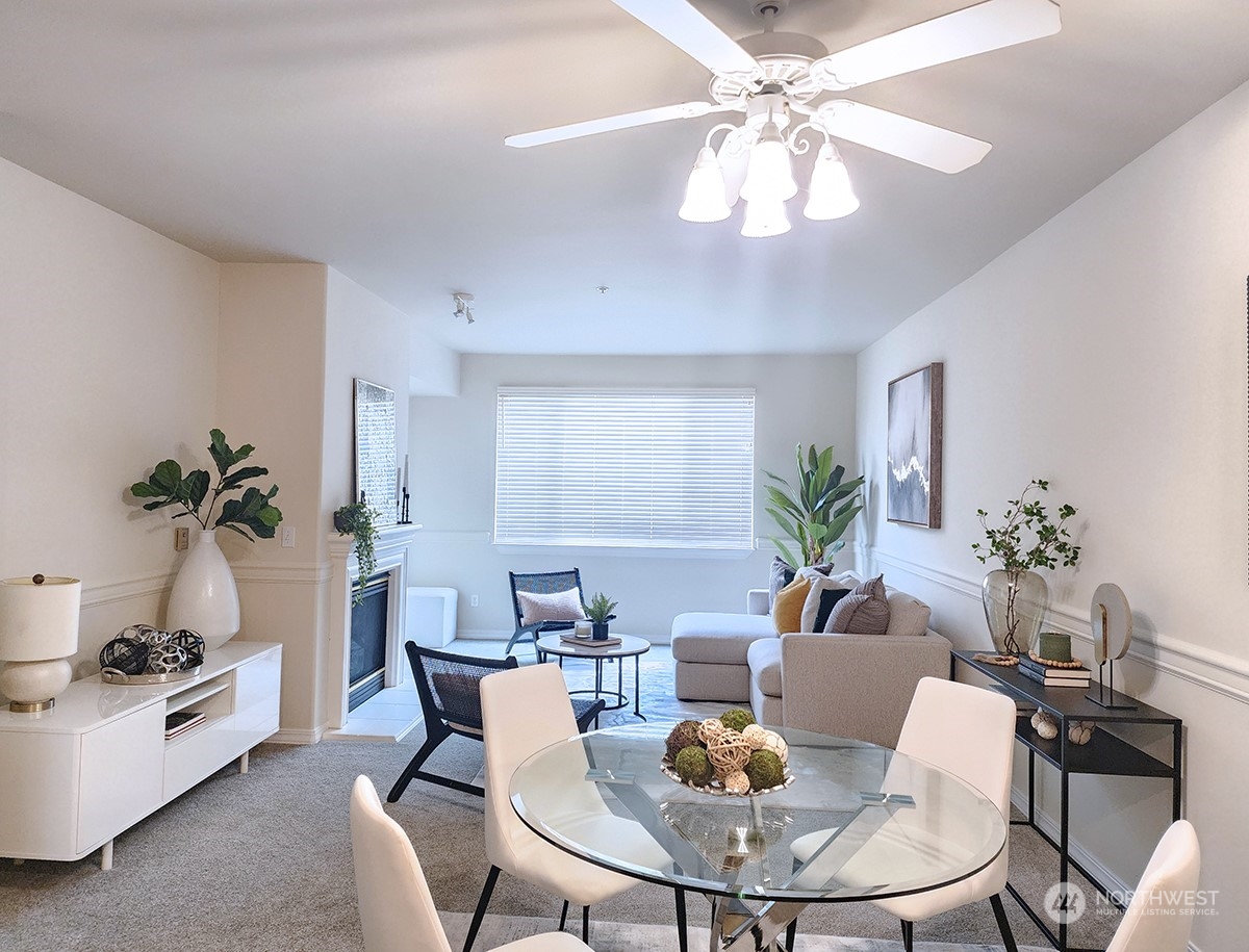 440 Maple Avenue Southwest, Unit A203 Renton, WA 98057 - Photo 18 of 33 a living room with furniture flowers and a chandelier