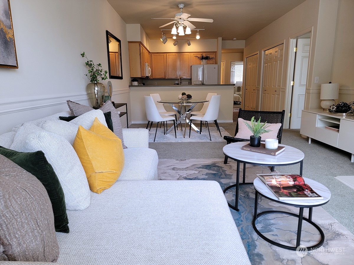 440 Maple Avenue Southwest, Unit A203 Renton, WA 98057 - Photo 25 of 33 a living room with furniture a rug and a chandelier