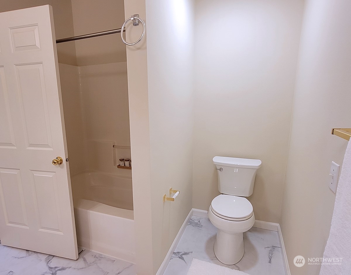 440 Maple Avenue Southwest, Unit A203 Renton, WA 98057 - Photo 29 of 33 a white toilet sitting next to a bath tub