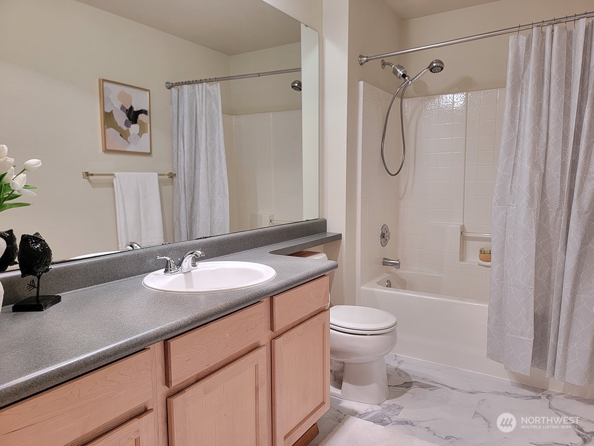 440 Maple Avenue Southwest, Unit A203 Renton, WA 98057 - Photo 4 of 33 a bathroom with a granite countertop sink toilet and shower