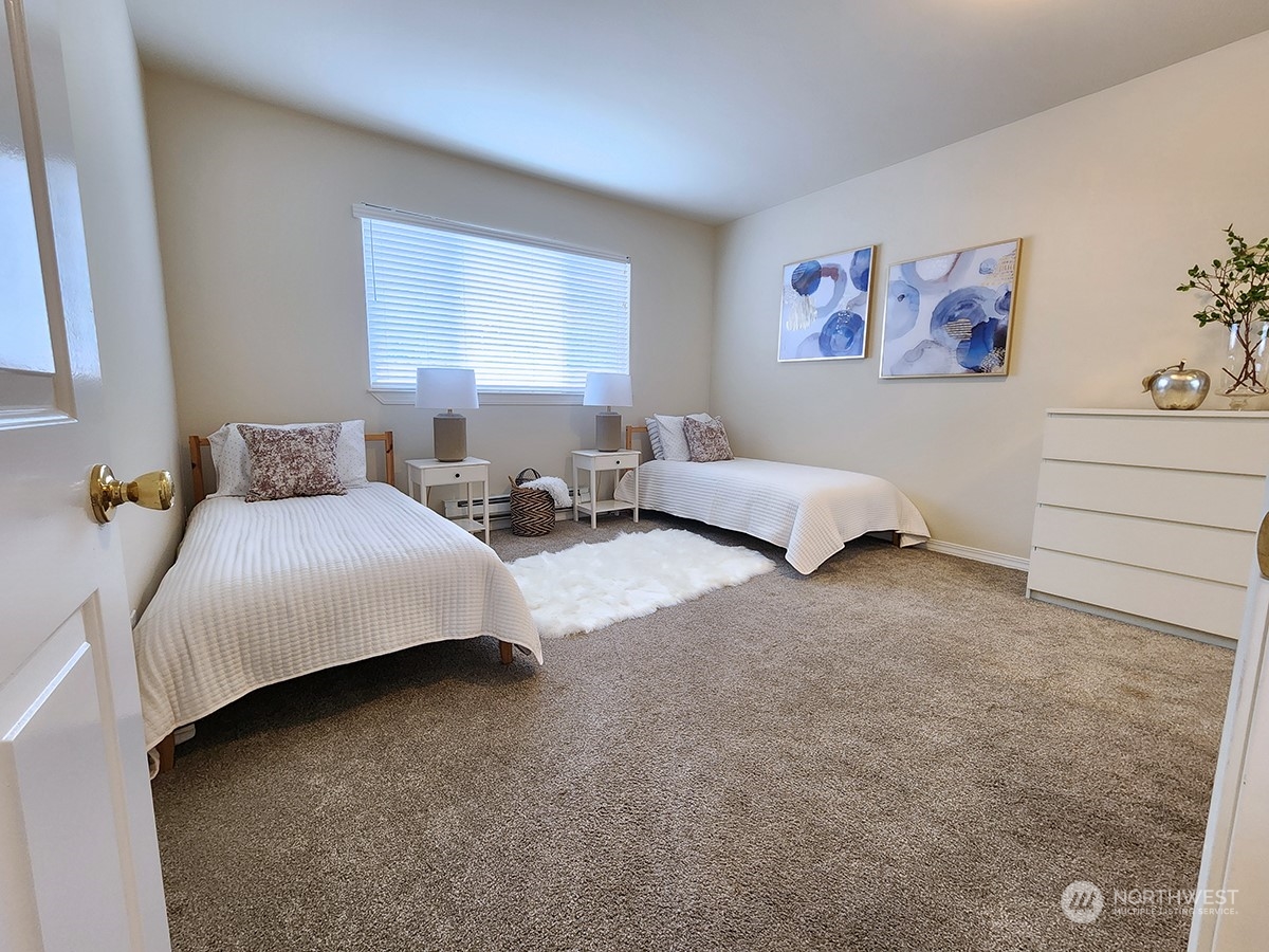 440 Maple Avenue Southwest, Unit A203 Renton, WA 98057 - Photo 8 of 33 a bedroom with bed and a couch