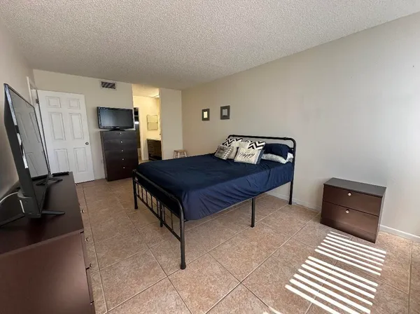 a bedroom with a bed and a tv