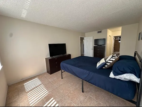 a kitchen with a refrigerator and a table