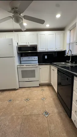 a kitchen with a stove and a refrigerator
