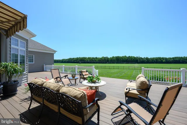 a view of a dining room with furniture wooden floor and chandelier
