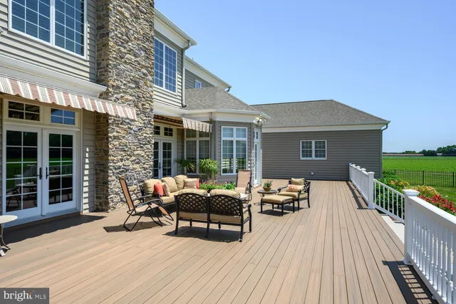 a view of a livingroom with wooden floor and furniture