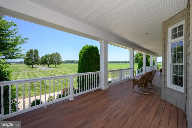 a kitchen with stainless steel appliances a table chairs refrigerator and cabinets
