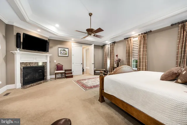 a view of a house with a big yard and large trees